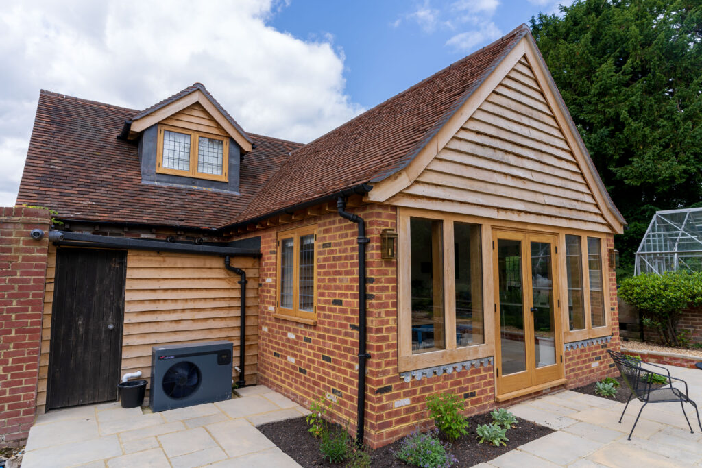 Naylands: bespoke barn conversion featuring an on-site oak gable, Bolney Stoves wood burner, Benchmarx kitchen, high-grade timber, full M&E works and refined finishes.
