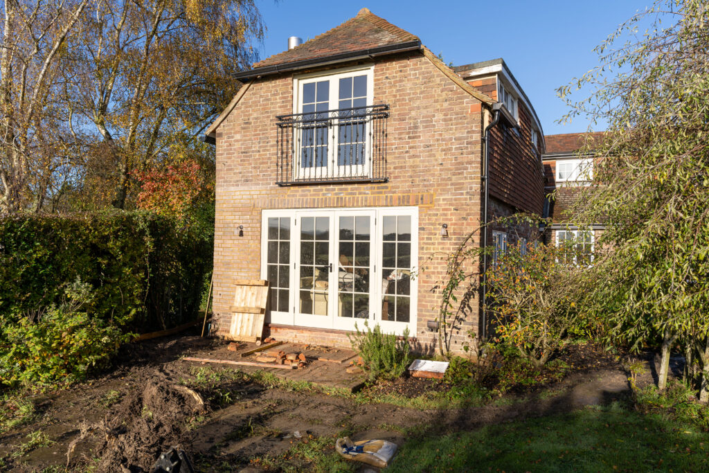 Longridge Barn, Lindfield: full barn conversion showcasing exposed beams, bespoke timber doors, underfloor heating, log burner, Juliet balcony, custom kitchen & joinery.