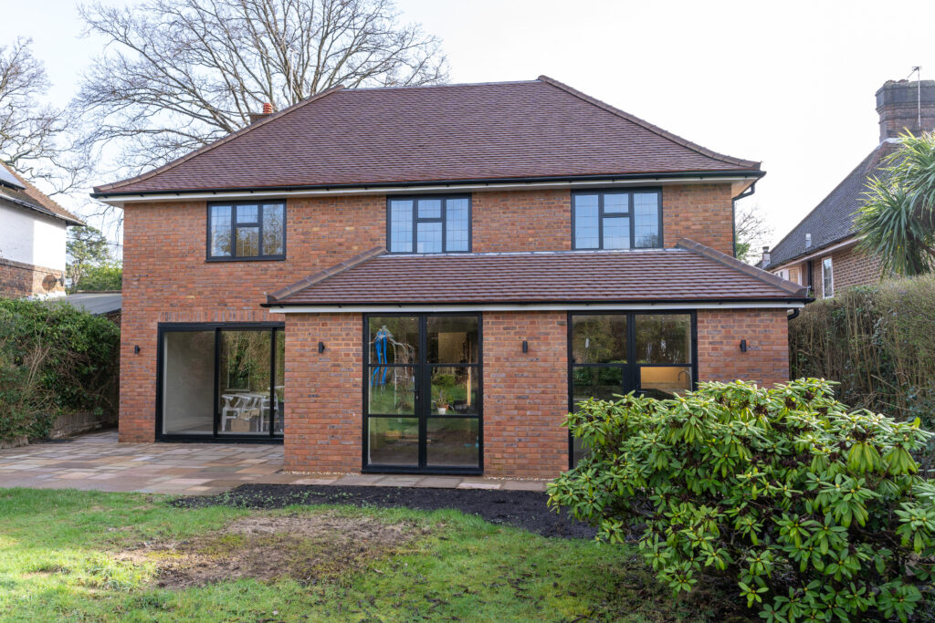 Summerhill: single- and two-storey garage extension with front, side & rear additions and roof remodel.